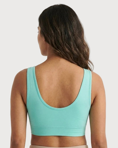 A woman viewed from the back wearing an aqua Original Ahh Bra® against a light gray studio background.