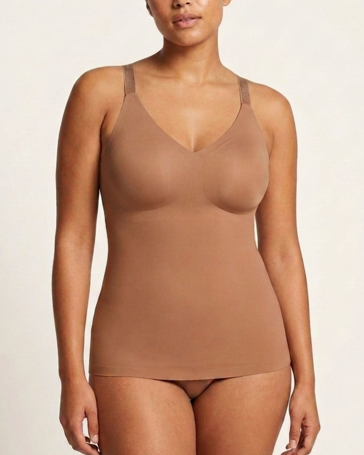 A woman modeling a mahogony Adjustable Strap Butterknit Tankagainst a plain light background.
